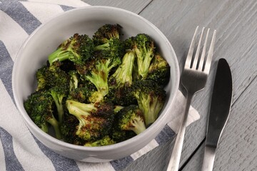 Tasty fried broccoli served on grey wooden table, above view