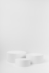 Abstract three white round podiums for cosmetic products as mockup on white background. Scene for presentation products, gifts, goods, advertising, design, sale, text, display, showing.