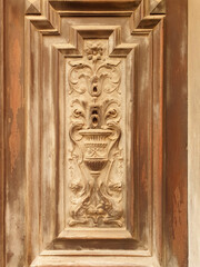 Ancient old door of a house on the street of Europe. Vertical.