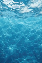 Fototapeta premium A serene image of a blue water surface with gentle ripples and clouds overhead. Ideal for nature-themed designs and backgrounds.