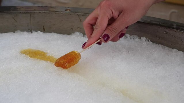 Female With Nail Varnish Rolling Maple Taffy