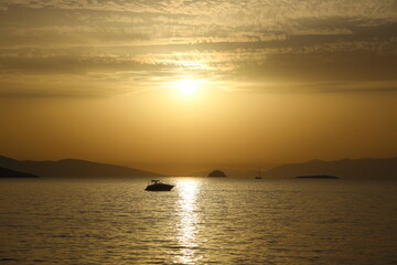Naklejka na ściany i meble sunset on the beach. Seaside town of Turgutreis and spectacular sunsets. Selective Focus.