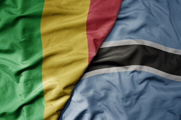 big waving national colorful flag of mali and national flag of botswana .