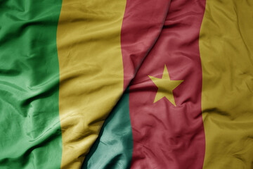 big waving national colorful flag of mali and national flag of cameroon .