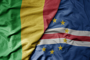 big waving national colorful flag of mali and national flag of cape verde .
