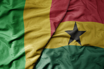 big waving national colorful flag of mali and national flag of ghana .