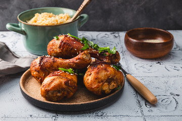 Chicken drumsticks with sesame seeds and rice, Asian cooked chicken on the table
