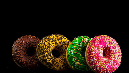  Glazed donuts with sprinkles isolated. Close up of colorful donuts.