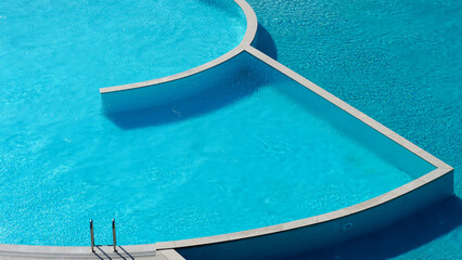 Turquoise and blue colored swimming pool which has two parts, one part is sweet water, the other salty water