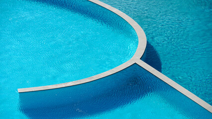 Turquoise and blue colored swimming pool which has two parts, one part is sweet water, the other...