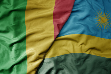 Fototapeta na wymiar big waving national colorful flag of mali and national flag of rwanda .