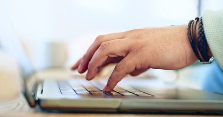 Fototapeta premium Typing, hands and man with remote work on laptop, desk and closeup on workplace in home. Computer, keyboard and person writing SEO, copywriting or working online with email marketing on the internet