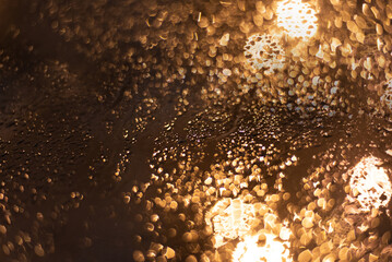 Blurred background with raindrops and lights.