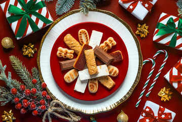 Top view of Nougat christmas sweet with christmas ornaments on a plate. Assortment of christmas...
