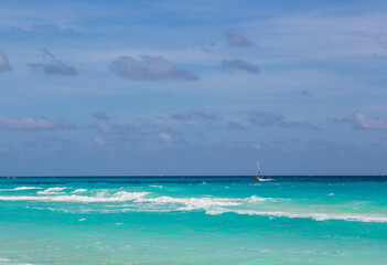 Turquoise water of Caribbean Sea, sandy beach, blue sky, good for background. Cancun, Mexico