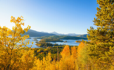 Autumn aspen trees, mountains, and lake landscape in Colorado 