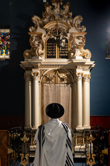 Jewish prayer leader in tallit and black hat
