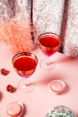 Two retro glasses with pink cocktail in a festive pink atmosphere, concept for Valentine's day