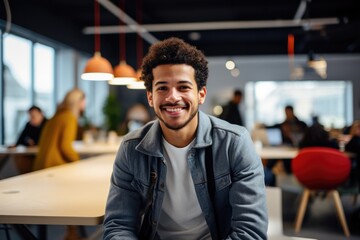 A young entrepreneur in a modern co-working space, engaged in a creative brainstorming session with fellow professionals, showcasing innovation and teamwork.