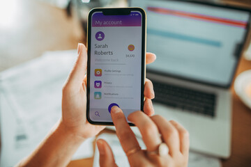 Woman checking her account details on a smartphone app