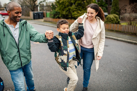 Family enjoying a walk together in their neighborhood