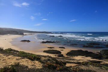 Beautiful Almograve beach with black basalt rocks in Portugal