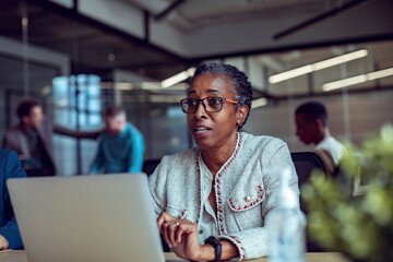 Senior businesswoman working on the laptop in the office