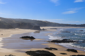 Beautiful Almograve beach with black basalt rocks in Portugal