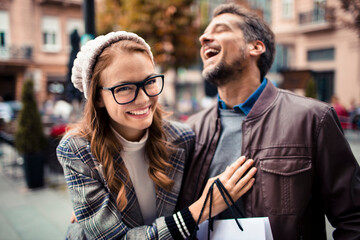 Excited couple enjoying a city shopping spree