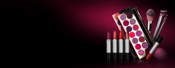 Eye shadow, blush brushes, purple, pink, red powder dust on black background. Highly vibrant...