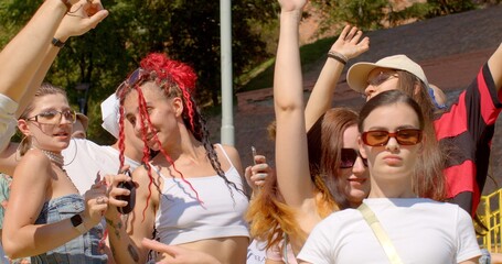 Students are dancing on a courtyard within the campus. Scene from a promotional video or advertisement for the university, highlighting the vibrant and active campus life.