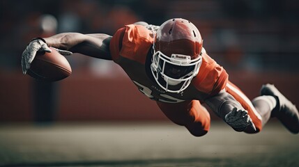 American football player making a diving catch, athleticism and intensity of the game - obrazy, fototapety, plakaty