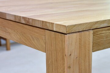 Wooden dinner table surface. Natural wood furniture close view