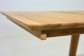 Wooden dinner table surface. Natural wood furniture close view