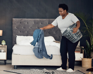 Black woman, clothes with basket and cleaning bedroom, organize mess with hygiene and hospitality....