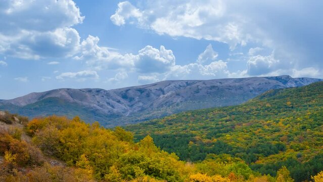 red autumn mountain valley under pale cloudy sky time lapse scene