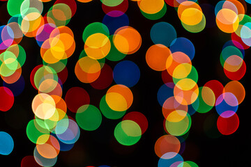 Christmas defocused lights, blurred colorful lights on a dark background, festive background
