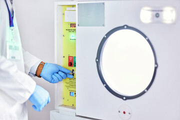 Laboratory, test and hands on button on machine for science research, experiment or innovation. Lab, scientist hand with glove and exam safety in technology for medical engineering and manufacturing.