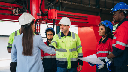 Team engineers and foreman stack hand and shake hands to show success at factory machines. Worker industry join hand for collaboration.