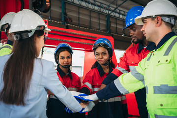 Team engineers and foreman stack hand and shake hands to show success at factory machines. Worker industry join hand for collaboration.