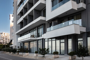 Fototapeta na wymiar Apartments. Buildings facade exterior with windows, palm trees, real estate property architecture