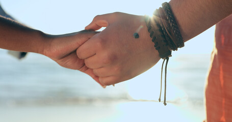 Love, zoom and couple holding hands at a beach with respect, gratitude and trust in nature...
