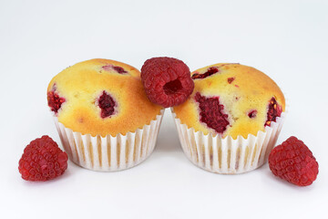 Muffins with raspberries on white background 