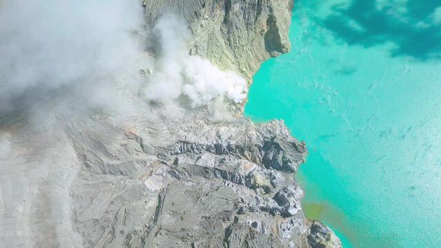 Top view on Beautiful view of sulfur emerald lake and Kawah Ijen volcano at East Java, Indonesia. Aerial Drone view