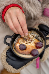 Cheese melts in pan on a gas burner during a picnic in mountains