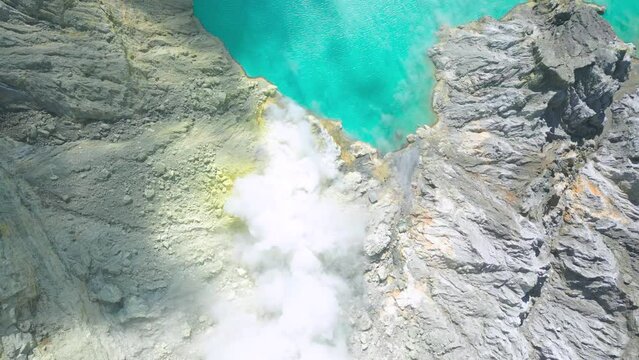 Top view on Beautiful view of sulfur emerald lake and Kawah Ijen volcano at East Java, Indonesia. Aerial Drone view 4K