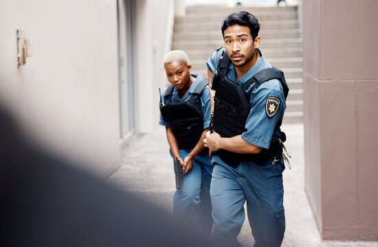 Asian man, police and gun running in city for suspect, investigation or catching criminal together. Serious male person, security guard or cop with partner for backup or crime in alley of urban town