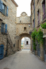 Fototapeta premium The clock arch at the main entrance of the charming medieval village of Montpeyroux, Auvergne, France.
