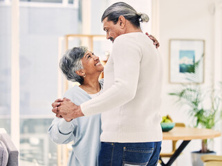 Senior couple, hug and holding hands in dance for love, care or bonding together in living room at home. Elderly man and woman enjoying quality time, weekend or holiday celebration for anniversary