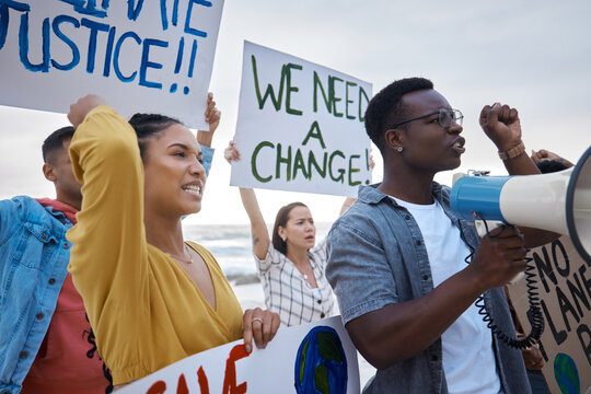 Angry, community and people at a protest for change, social justice and freedom together. Banner, power and group of protesters in a crowd for a revolution, speech and movement for equality fight